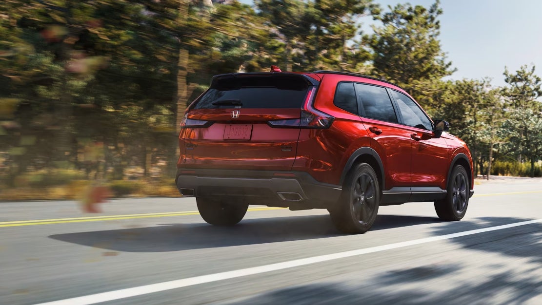 Red 2026 Honda CR-V on Road with Trees