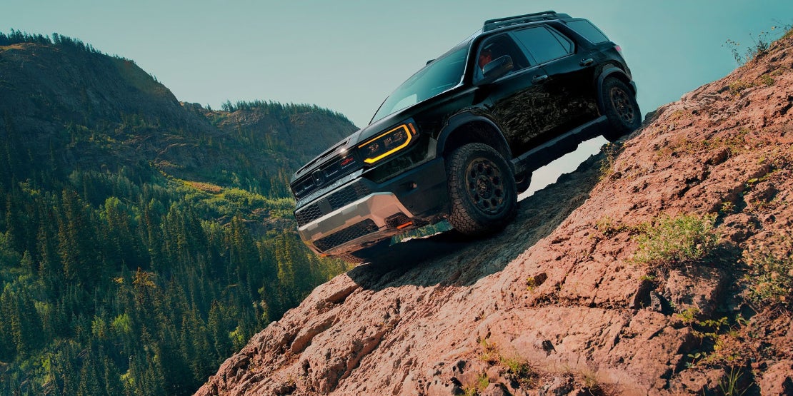 A black 2026 Honda Passport SUV parked on a steep rock cliff