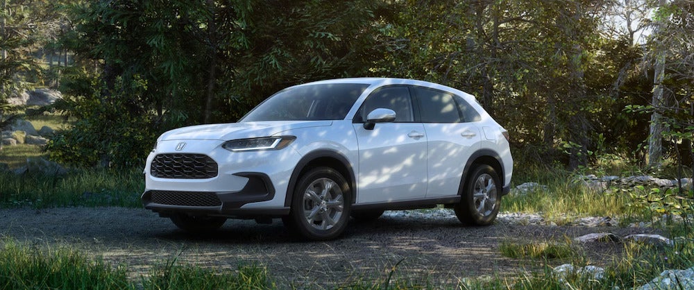 A white 2026 Honda HR-V parked in a wooded area
